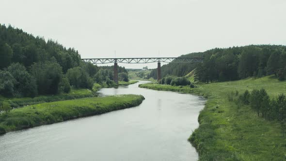 Aerial View of the Railway Bridge Over the River in the Forest