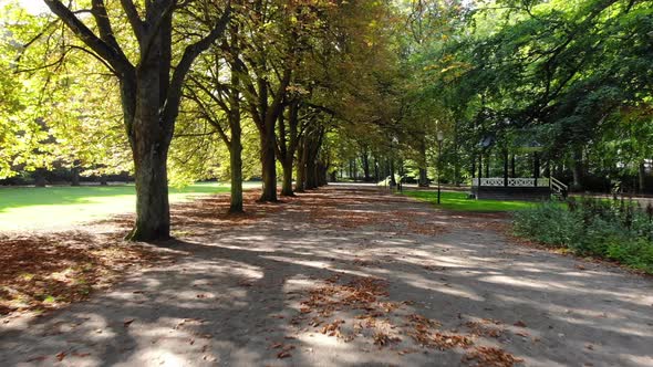 Drone flying low through park, day time in late summer