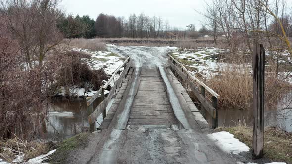 Crossing the River Over a Wooden Road Bridge in the Spring