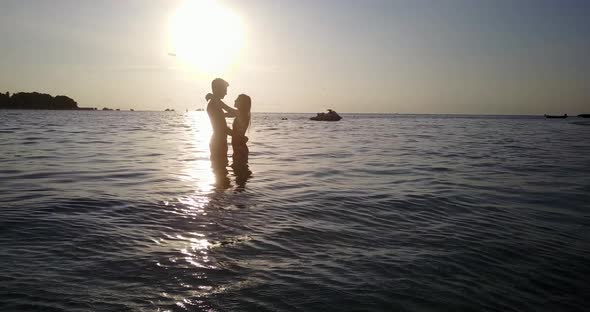 Beautiful lady and man on romantic honeymoon enjoy life on beach on summer white sandy background 4K