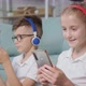 Portrait of Twins Girl and Boy Listening to Music Using Phone and Headphones - VideoHive Item for Sale
