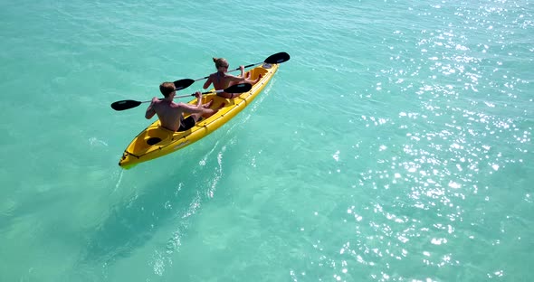 Happy couple on romantic honeymoon live the dream on beach on sunny white sandy 4K background