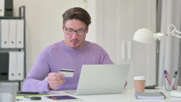 Successful Online Payment on Laptop By Middle Aged Man