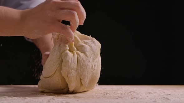 Woman Hands Kneading Dough in Flour on the Table