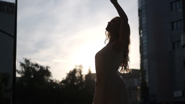 Silhouette of an Attractive Girl Dancing Outdoors in the City