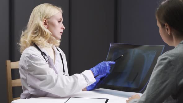Female Doctor Explain Xray Chest Result in Computer Laptop To Illness Woman Patient in Examination