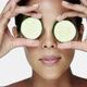 Woman holding cucumber slices over her eyes - VideoHive Item for Sale