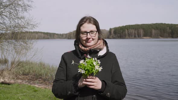 Portrait of Simple Woman in Glasses Near Lake