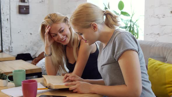 Two Girls Are Reading a Book