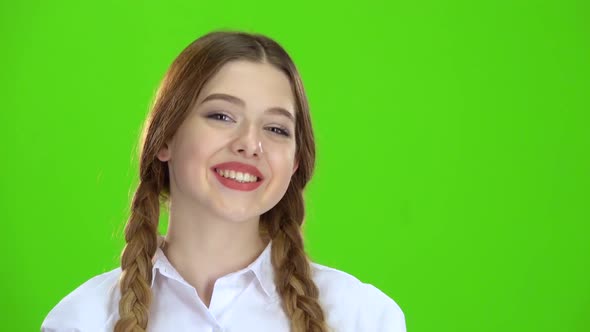 Girl Shows the Heart Shape and Smiles. Green Screen