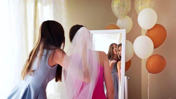 Smiling Bride and Bridesmaid Makig Faces.