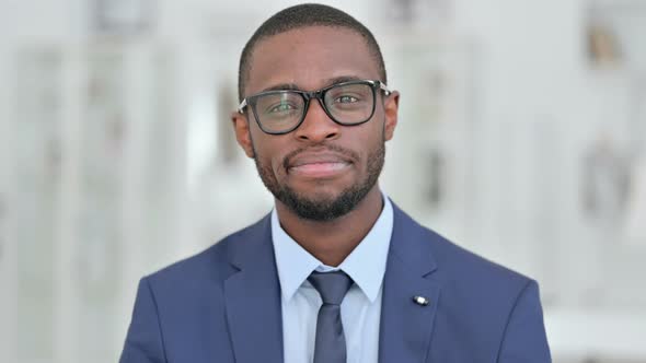 Portrait of Cheerful African Businessman Doing Video Call 