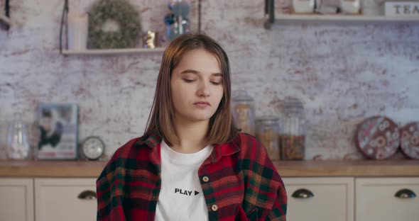 A Young Girl Bites a Red Apple with Pleasure. 