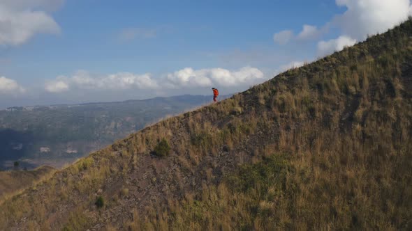 Drone View of Woman Tourist Walking Down Mountain Hill