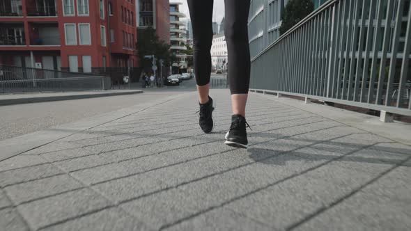 Close Up of Female Legs in Sportswear Running Outdoors