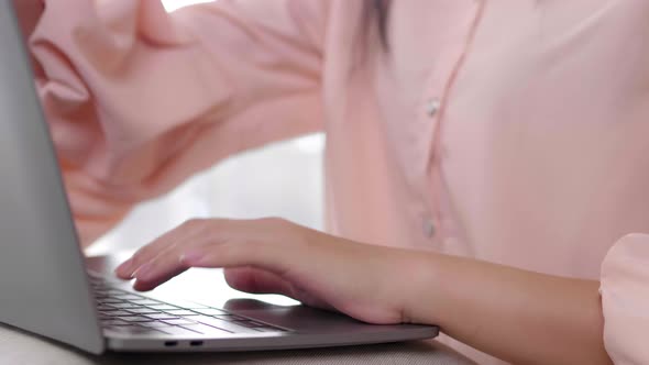 Close up of hand, woman working on laptop by typing and then taking a break and close her laptop