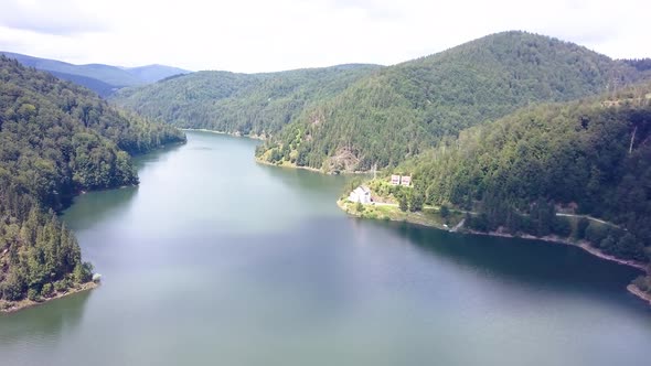 Spinning aerial shot over the top of a mountain lake.