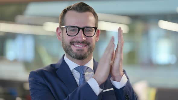 Portrait of Middle Aged Businessman Clapping Applauding