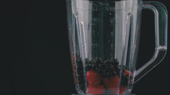 Milk is Poured Into a Blender Bowl with Berries