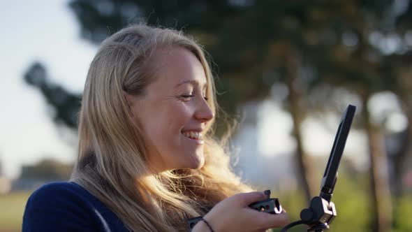 Female Film Maker Smiling As She Films