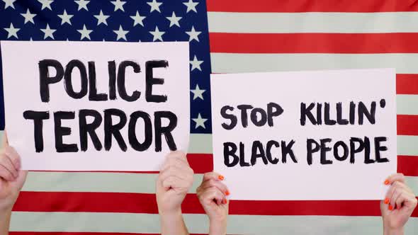 Protesters Hold Banners with Slogans - Police Terror. Stop Killing Black People - Against Background
