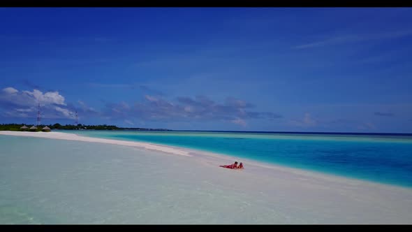 Man and lady sunbathe on paradise lagoon beach trip by blue water and white sandy background of the 