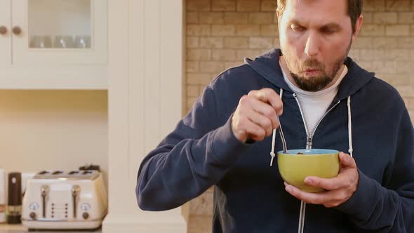 Young man having breakfast in the kitchen 4K 4k