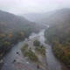 a Misty River in the Mountains with a Yellowgreen Forest From a Bird'seye View - VideoHive Item for Sale