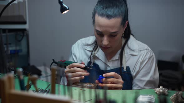 Front View Concentrated Jeweller Working with Equipment in Workshop Indoors