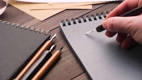 Crop Person Drawing Heart in Notebook