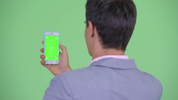 Closeup Rear View of Happy Young Businessman Using Phone