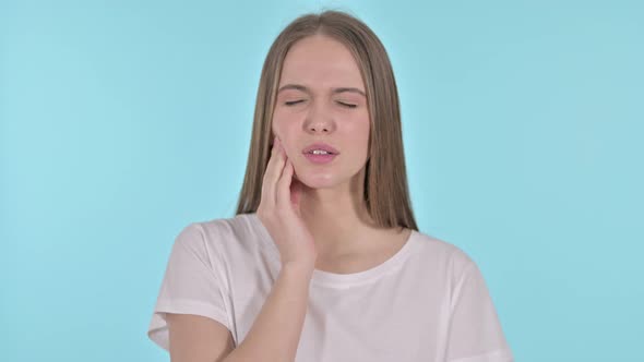 Portrait of Beautiful Young Woman Having Toothache, Blue Background