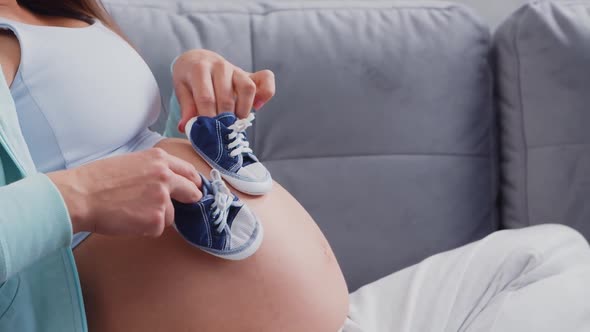 Young pregnant woman is resting at home and expecting a baby.