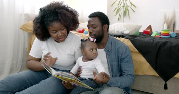 Parents and Toddler Daughter Having Fun Playing at Home