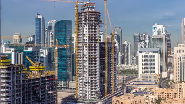 Construction Activity in Dubai Downtown with Cranes and Workers Timelapse UAE