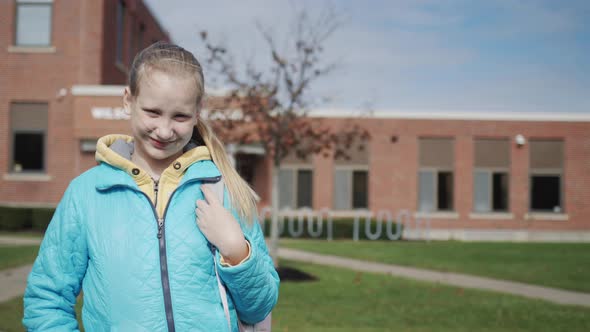 Portrait of an American Student in Front of a High School Building