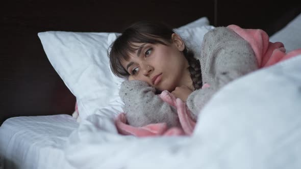 Upset Woman Lying in a Bed and Thinking