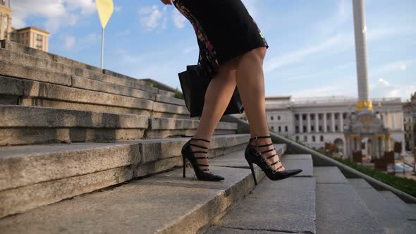 Businesswoman's Legs in Heels Stepping Down Stairs