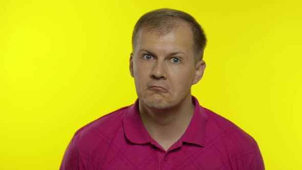 Portrait of Young Caucasian Man Posing in Pink T-shirt. Confused Handsome Guy Shocked, Surprised