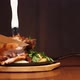 A Man's Hand Cuts an Appetizing Meat Dish Into the Bone with a Knife. Ready Meat Dish with Garnish - VideoHive Item for Sale