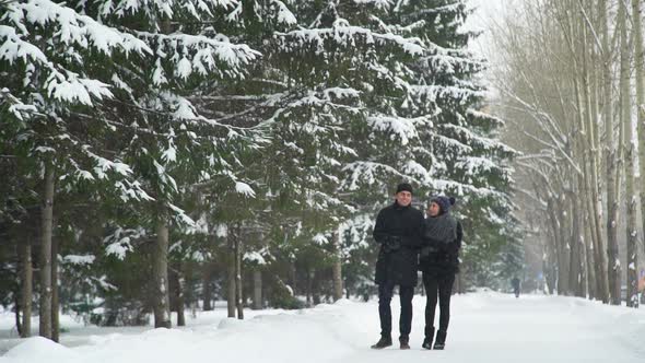 Man and Woman Walk in Winter Park