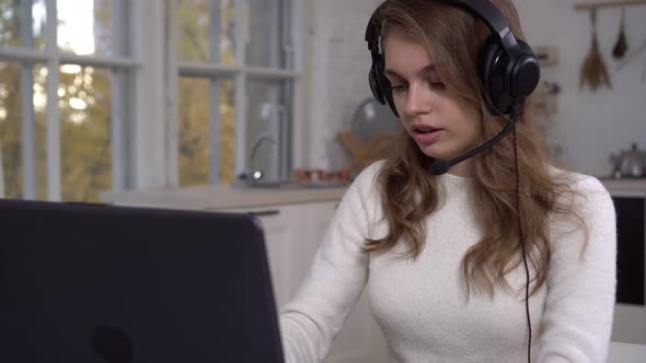 Beautiful Freelance Woman Talking at Home Via Video Conference with Laptop