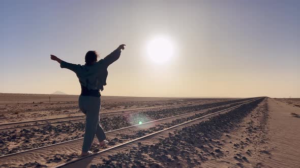 Young Woman Walks at Abandoned Railway Near Garub Railroad Station