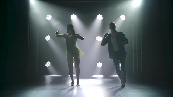 Concept of Social Dance and Relationships, Silhouette of Young Beautiful Couple Dancing Sensual