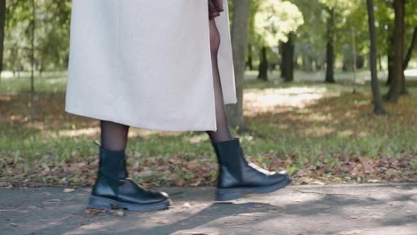 Closeup Shot of Girl's Feet Walking in the Park on a Sunny Autumn Day