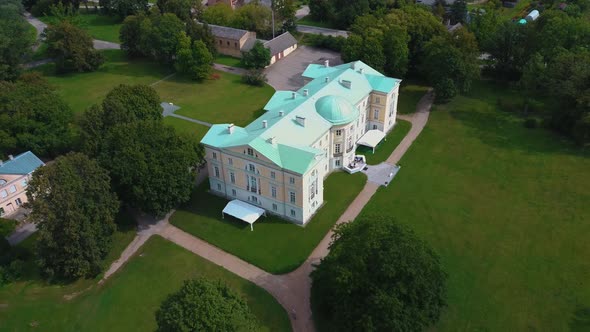 Mezotne Palace and Park With Fountain in Latvia. Lielupe River With Ponton Bridge Aerial 4K