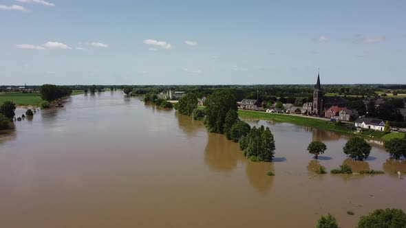 Flooded land and floodplains, drowned trees, river Maas village Appeltern