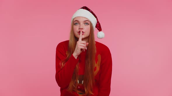 Woman Wears Red Christmas Sweater Presses Index Finger to Lips Makes Silence Gesture Sign Secret