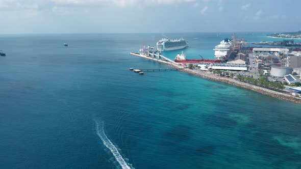 Aerial shot of a pier with cruise liners and a barge and sailing boat in Bridgetown, Barbados