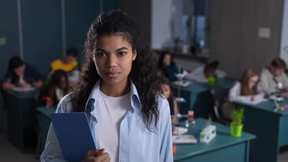 Cheerful Mixed Race Teacher Smiling on Camera